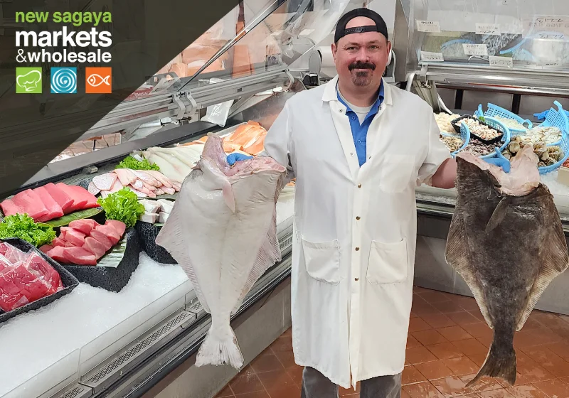 a man holding two fish in a store